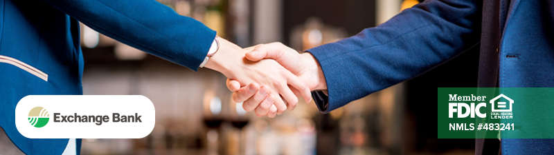 Business owner and business banker shaking hands