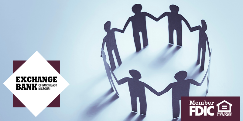 Silhouette of people holding hands in a circle